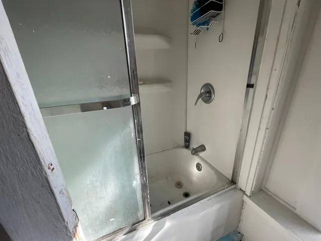 a bathroom with a tub and shower