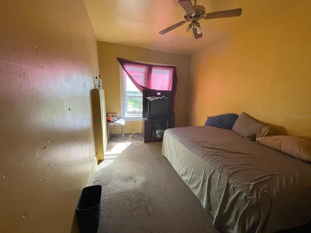 a bedroom with a bed and a chandelier