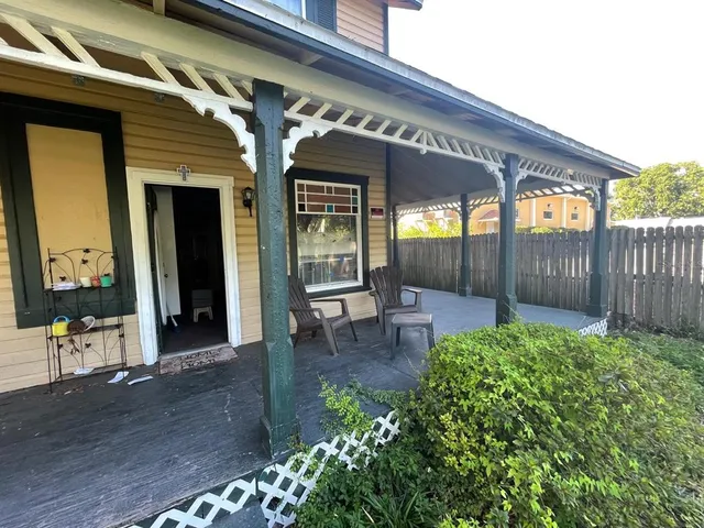 a view of a porch with chairs and backyard