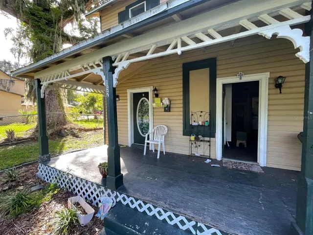 a front view of a house with outdoor seating