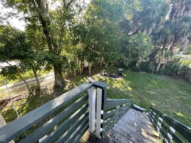 a view of a wooden deck and a yard