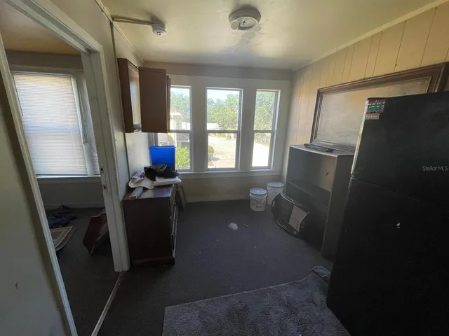 a room with wooden floor and furniture