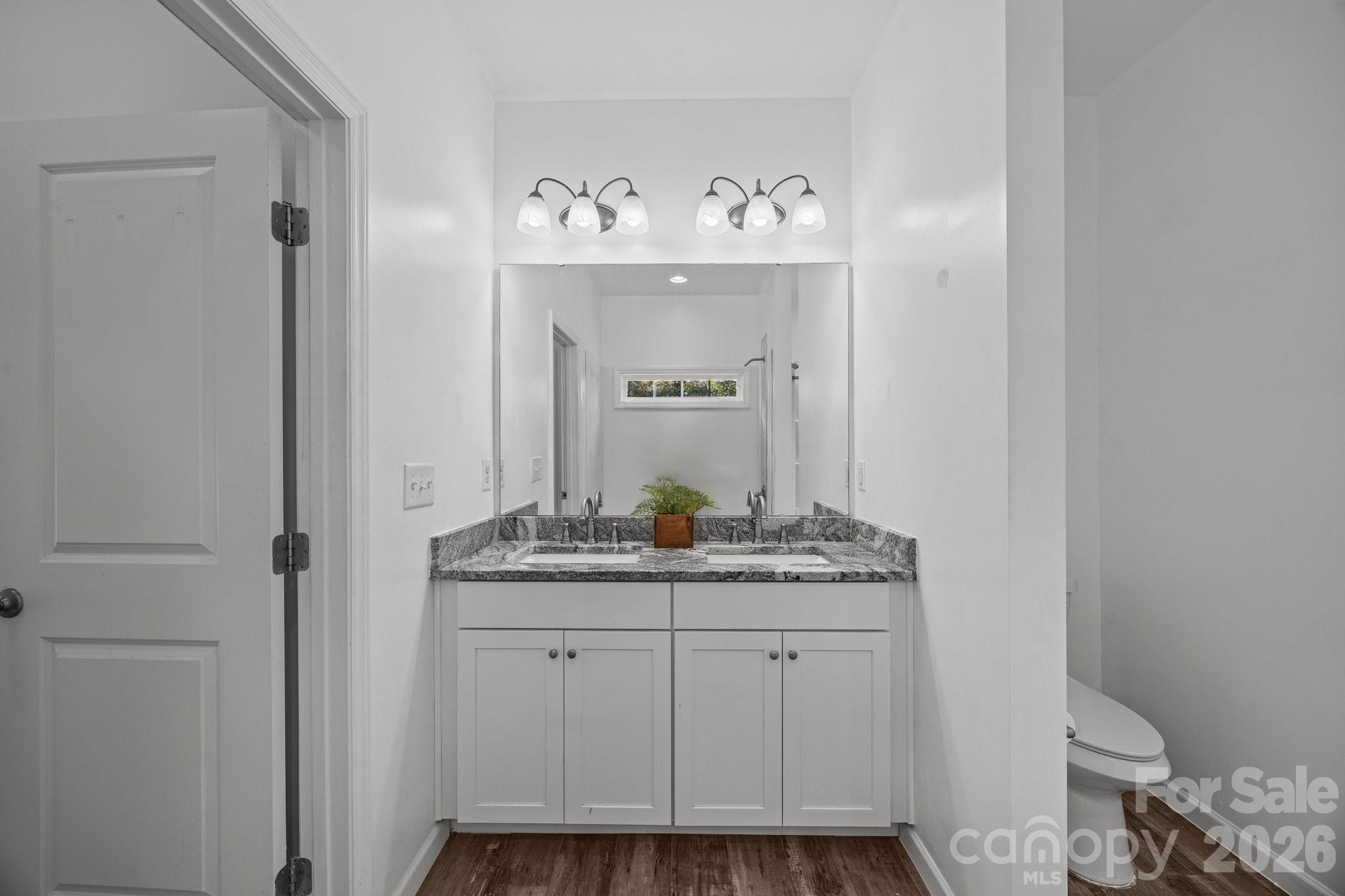 14532 East Rocky River Road Davidson, NC 28036 - Photo 25 of 32 a bathroom with a sink and a mirror