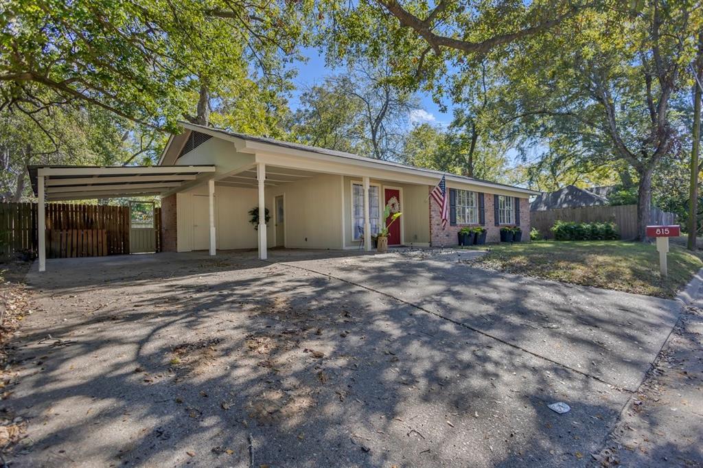 815 North Bledsoe Street Gilmer, TX 75644 - Photo 2 of 26 front view of a house with a yard and potted plants