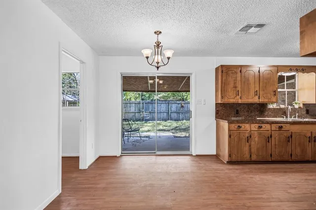 a view of a kitchen with a sink and a window