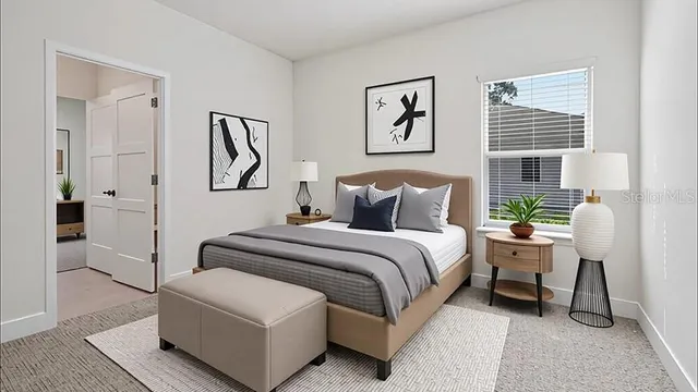 a bedroom with a bed and a painting on the wall