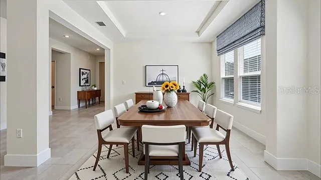 a dining room with furniture and window