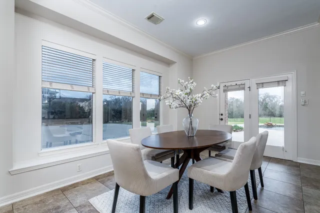 a dining room with furniture and window