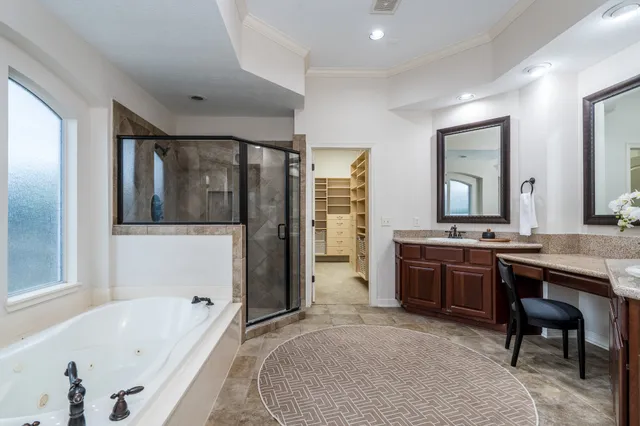a bathroom with a tub sink and mirror