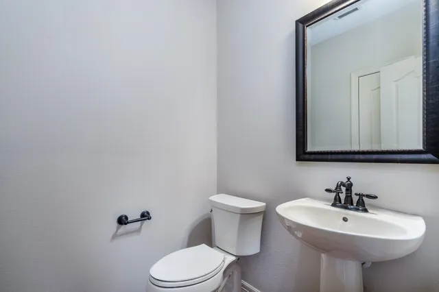 a bathroom with a sink a mirror and a toilet