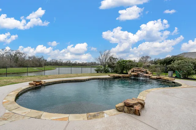 a front view of a house with swimming pool having outdoor seating