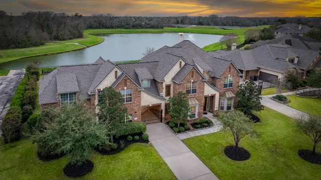 an aerial view of a house with garden space and lake view