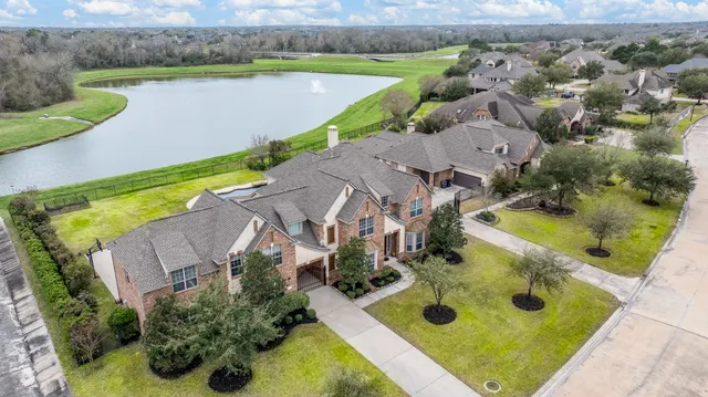 an aerial view of a house with a swimming pool