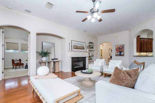 a living room with furniture a fireplace and a flat screen tv