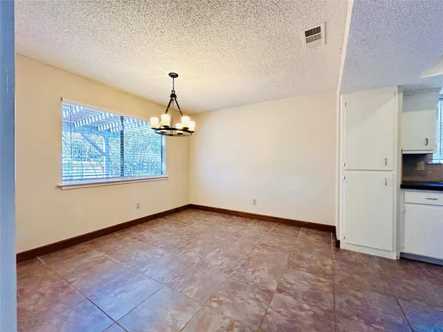 a kitchen with granite countertop white cabinets and stainless steel appliances