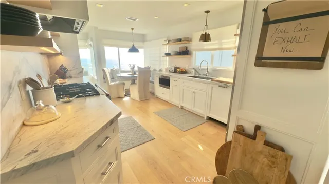 a kitchen with a sink appliances and cabinets