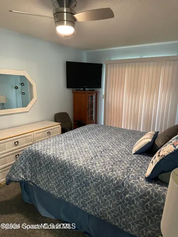 a bedroom with a bed and flat screen tv