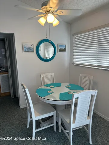 a dining room with furniture and a window