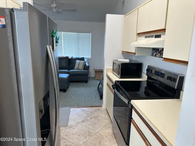 a kitchen with stainless steel appliances a stove microwave and a refrigerator