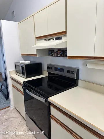 a stove top oven sitting inside of a kitchen