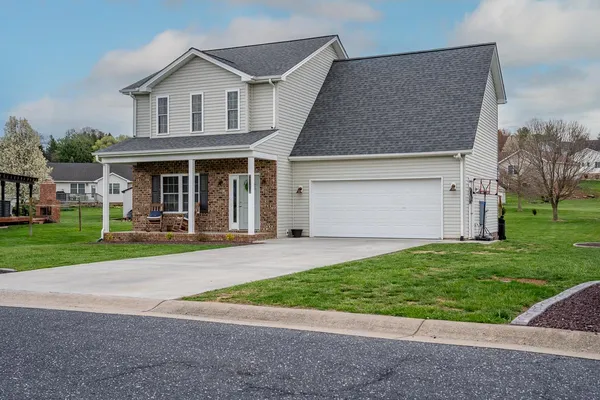 a front view of house with yard and green space