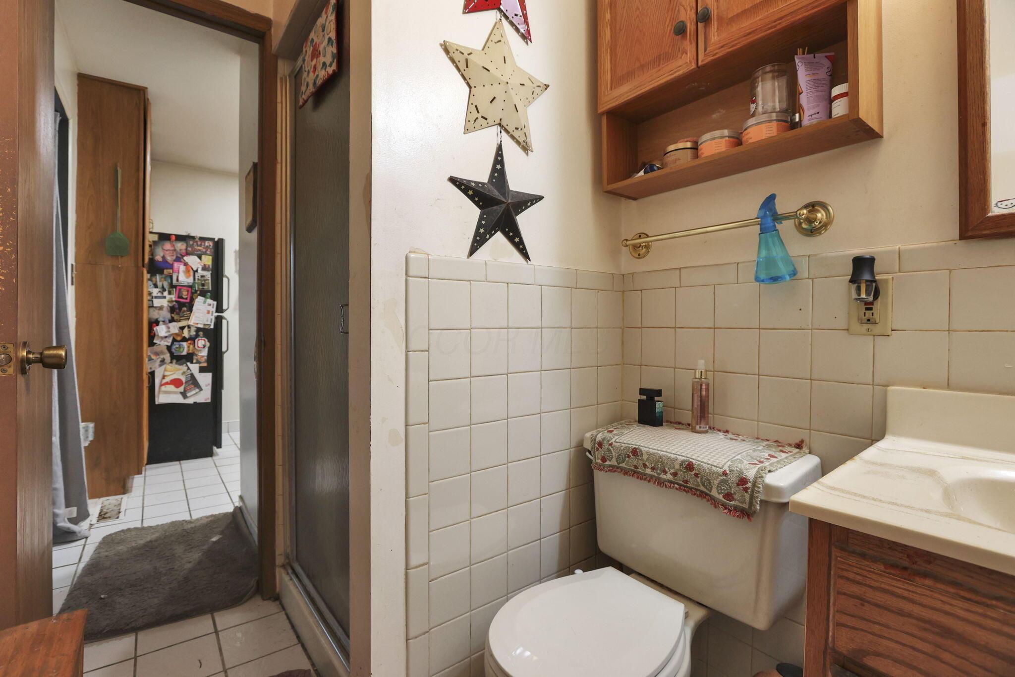 4969 Lockbourne Road Columbus, OH 43207 - Photo 13 of 32 Full bathroom with walk in shower services the primary bedroom and also the bonus space which could be used as a teen/in-law suite