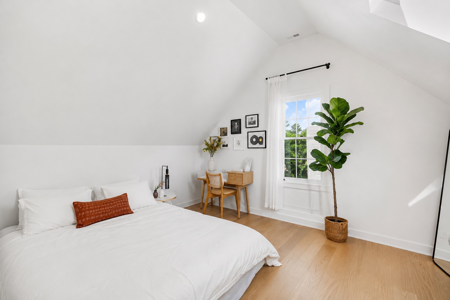 5007 Lott Avenue, Unit 1 Austin, TX 78721 - Photo 14 of 24 Sloping ceilings and a sun-drenched window create an inviting atmosphere in this upper-level sleeping area.