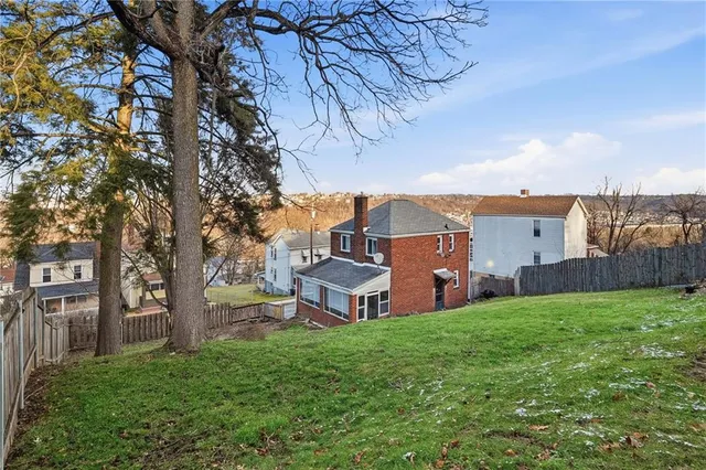 a view of a house with a yard and sitting area