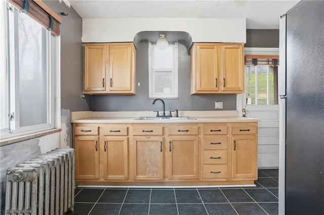 a bathroom with granite countertop a sink a vanity and a mirror