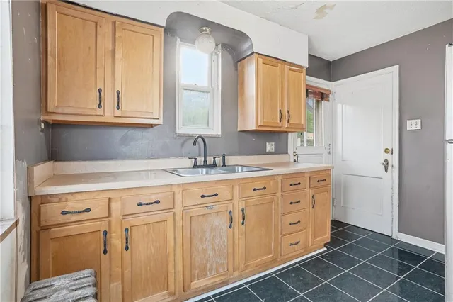 a bathroom with a double vanity sink and a window