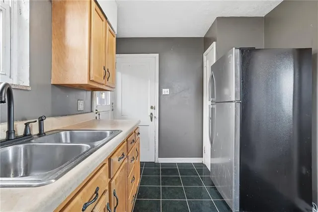 a kitchen with refrigerator cabinets and a sink