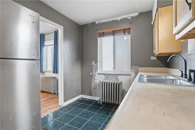 a kitchen with stainless steel appliances a sink and cabinets