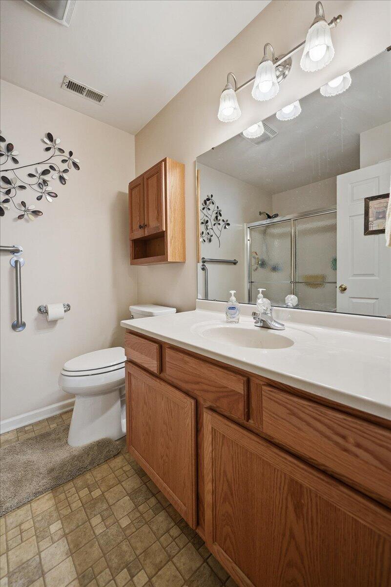 352 West 43rd Court Griffith, IN 46319 - Photo 14 of 19 a bathroom with a sink a toilet and a mirror
