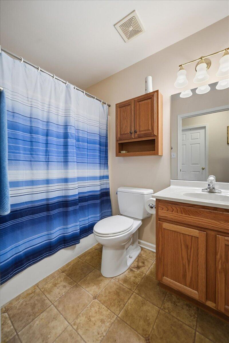 352 West 43rd Court Griffith, IN 46319 - Photo 15 of 19 a bathroom with a toilet a sink and mirror