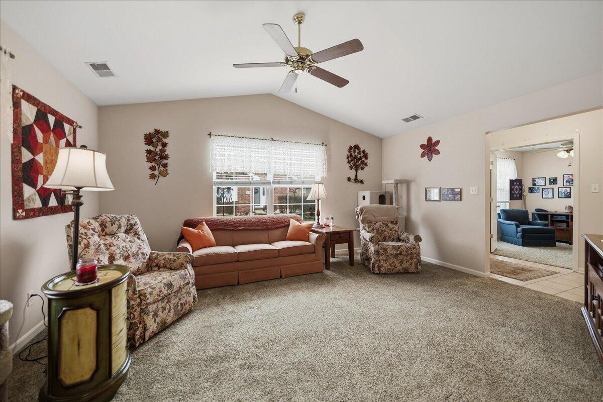 352 West 43rd Court Griffith, IN 46319 - Photo 4 of 19 a living room with furniture and a chandelier