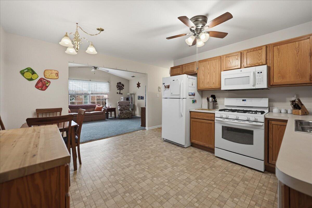 352 West 43rd Court Griffith, IN 46319 - Photo 7 of 19 a kitchen with cabinets a refrigerator and a stove top oven