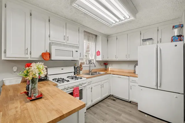a kitchen with a refrigerator and cabinets