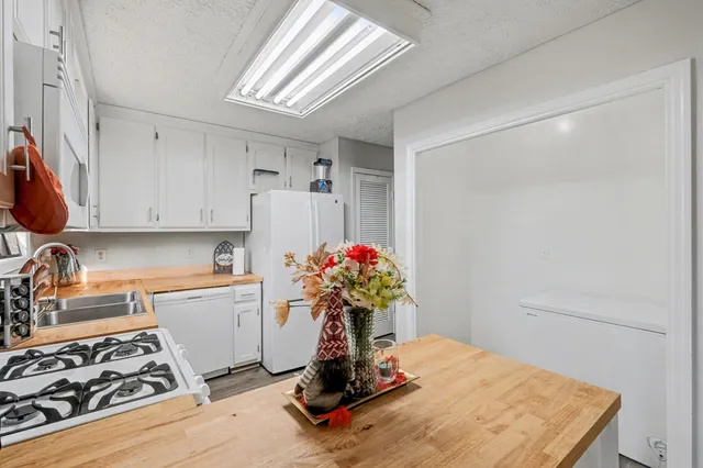 a utility room with cabinets a washer and dryer