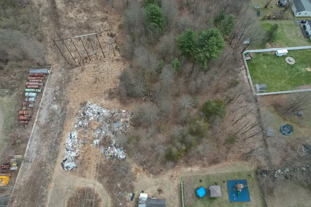 a view of a dry yard with trees
