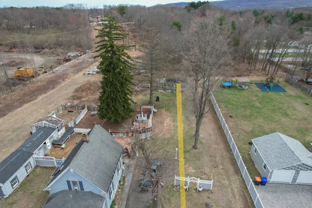 a swimming pool with yard in front of it