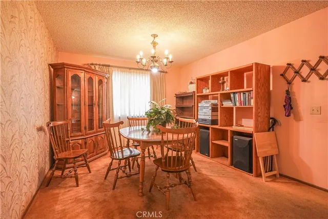 a view of a dining room with furniture and chandelier