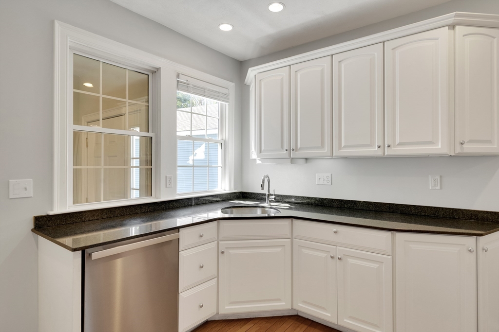 66 Webster Street, Unit 66 Newton, MA 02465 - Photo 13 of 40 a kitchen with granite countertop white cabinets and sink