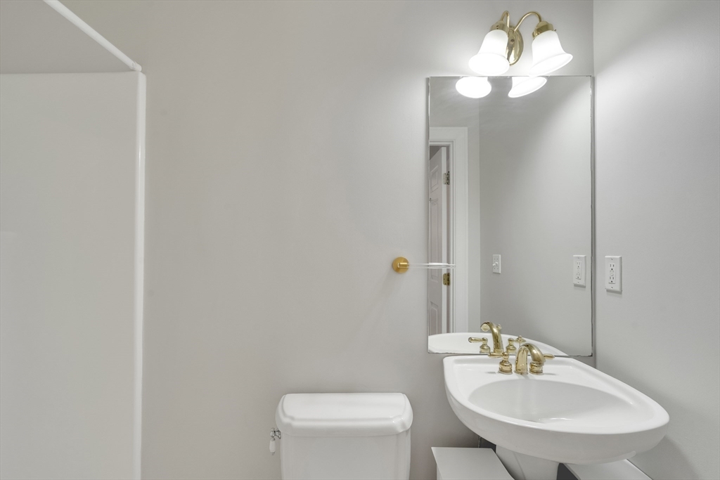 66 Webster Street, Unit 66 Newton, MA 02465 - Photo 17 of 40 a bathroom with a sink a toilet and a mirror