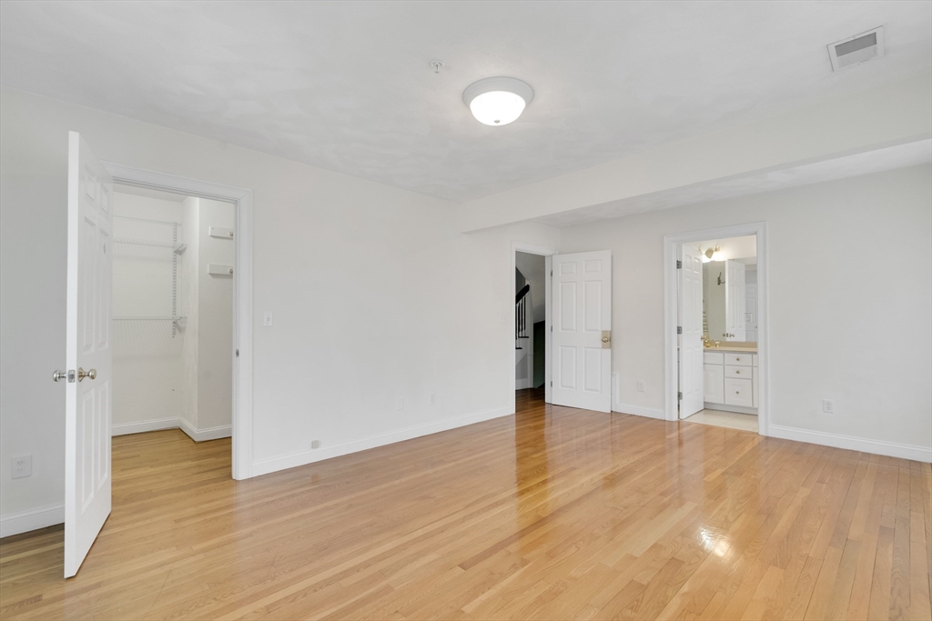 66 Webster Street, Unit 66 Newton, MA 02465 - Photo 20 of 40 a view of an empty room and wooden floor