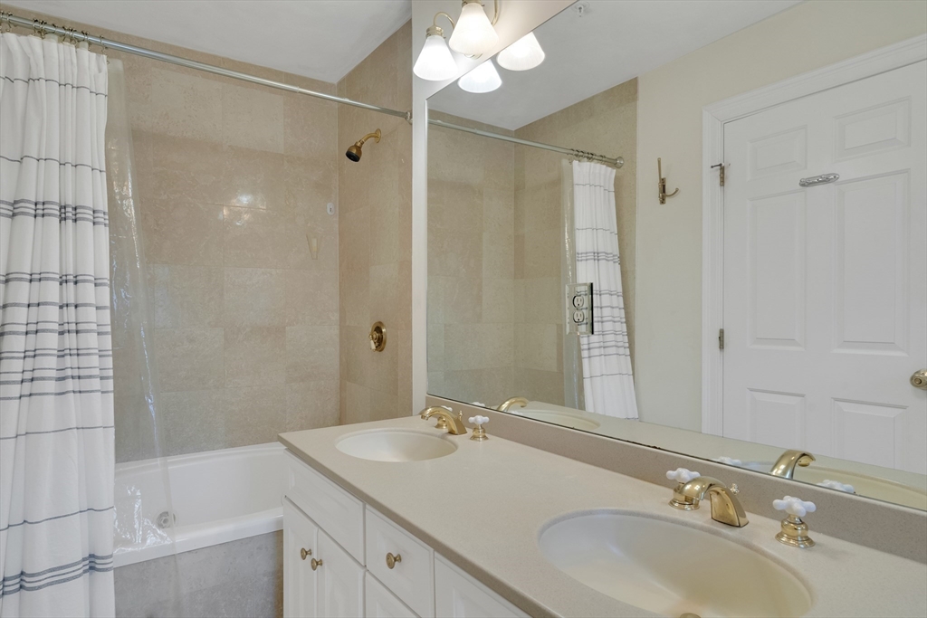 66 Webster Street, Unit 66 Newton, MA 02465 - Photo 22 of 40 a bathroom with a sink and a mirror