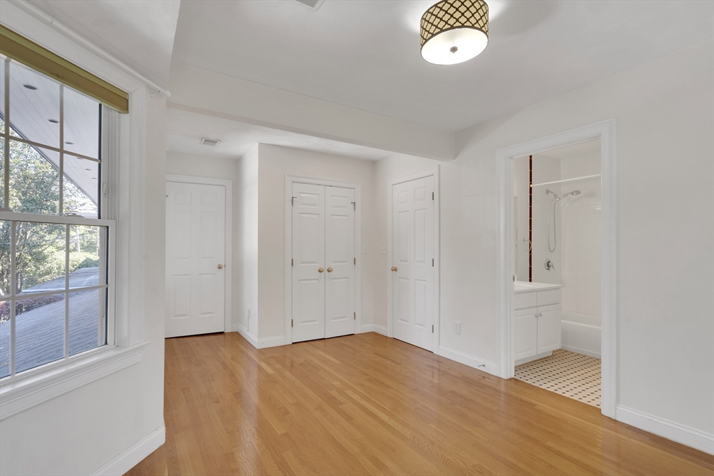 66 Webster Street, Unit 66 Newton, MA 02465 - Photo 25 of 40 a view of empty room with wooden floor and fan