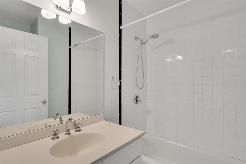 66 Webster Street, Unit 66 Newton, MA 02465 - Photo 26 of 40 a bathroom with a sink a shower and a mirror