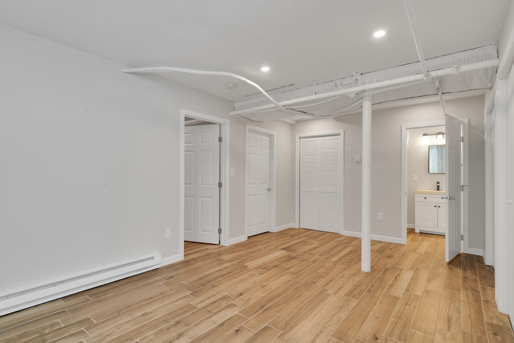 66 Webster Street, Unit 66 Newton, MA 02465 - Photo 34 of 40 a view of hallway with wooden floor