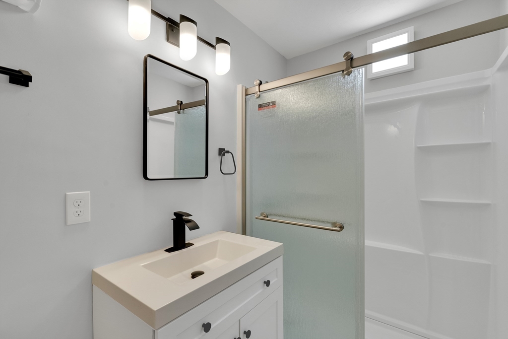 66 Webster Street, Unit 66 Newton, MA 02465 - Photo 35 of 40 a bathroom with a sink mirror and shower