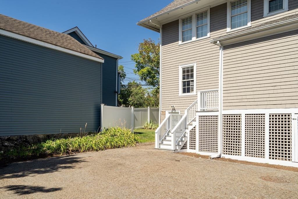 66 Webster Street, Unit 66 Newton, MA 02465 - Photo 38 of 40 a front view of a house with a yard and garage